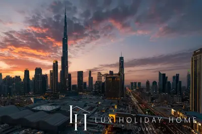 a view of a city at sunset with the words happy holiday home at LUX The Vida Burj Khalifa View Suite in Dubai
