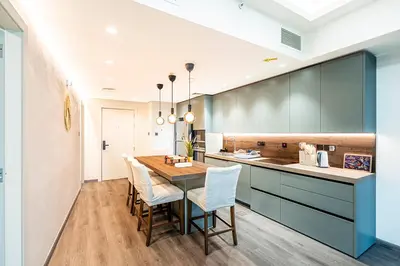 a kitchen with a long table and chairs at Escape24 Luxury 2BR with Large Balcony and Lake Views in Dubai