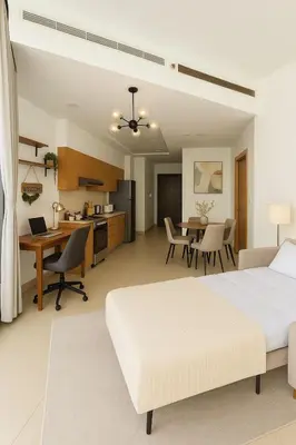 a bedroom with a bed and a desk and a kitchen at Burj Khalifa View 1BHK 5 people Downtown Dubai in Dubai