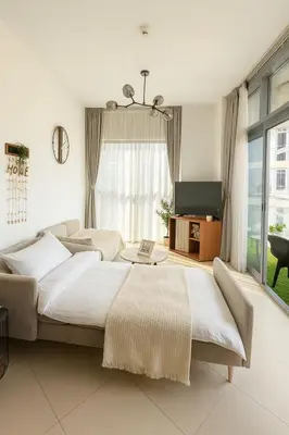 a bedroom with a large bed and a tv at Burj Khalifa View 1BHK 5 people Downtown Dubai in Dubai
