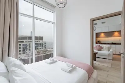 a bedroom with a large window and a white bed at Chic 2BHK Retreat with Marina Views by Czechin in Dubai