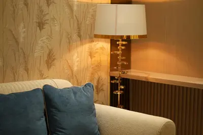 a living room with a couch and a lamp at The Royale Blue Suite 610 I JVC I Plunge Pool Parking Gym in Dubai
