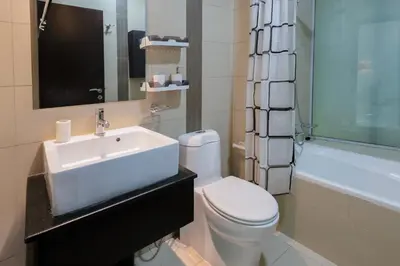 a bathroom with a sink and a toilet and a tub at 1BHK at Panoramic Tower, Marina with Sea and Canal View in Dubai