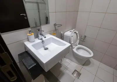a bathroom with a white sink and a toilet at 1BHK at Panoramic Tower, Marina with Sea and Canal View in Dubai