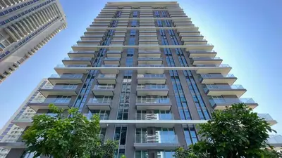 a tall building with trees in front of it at TRPS - Beach Isle Tower 1, Dubai Harbour - Seaside Residence, Private Beach, Palm View in Dubai