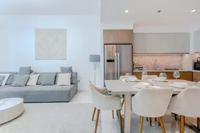a kitchen and living room with a table and chairs at TRPS - Beach Isle Tower 1, Dubai Harbour - Seaside Residence, Private Beach, Palm View in Dubai