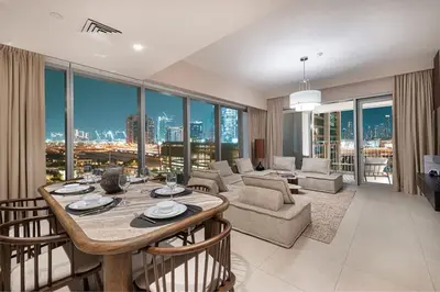 a living room with a table and chairs and a couch at Luxury 4BR Burj Khalifa View Dubai Mall in Dubai