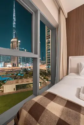 a bedroom with a view of a city skyline at Luxury 4BR Burj Khalifa View Dubai Mall in Dubai