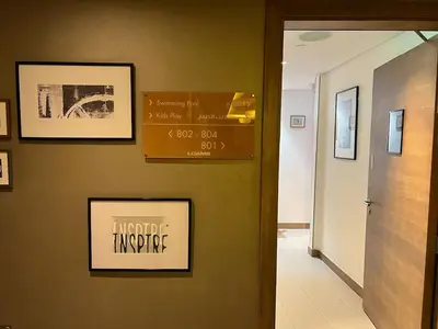 a hallway with two pictures on the wall and a door at Burj Khalifa View High Floor and Brand New in Dubai