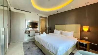 a bedroom with a large white bed in a room at Burj Khalifa View High Floor and Brand New in Dubai