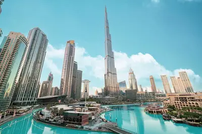 a view of a city with a river and skyscrapers at Panoramic 4BR Burj Khalifa & Fountain View in Dubai