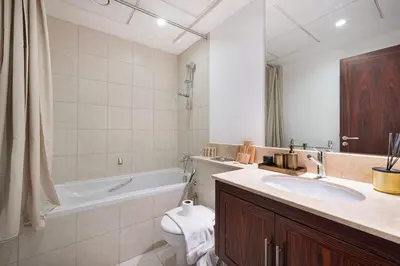 a bathroom with a sink and a tub and a toilet at Panoramic 4BR Burj Khalifa & Fountain View in Dubai