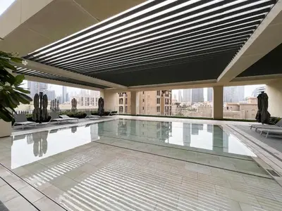 a swimming pool in the middle of a building at Cozy 1Bedroom Apartment Downtown Dubai Retreat in Dubai