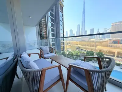 a balcony with two chairs and a table on a building at Center to Burj Khalifa I Brand New I High End in Dubai