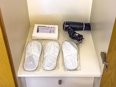 a cabinet with a blow dryer and a pair of shoes at Stunning Skyline Views and Prime Walkable Location in Dubai