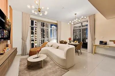 a living room with a couch and a table at Luxury 2BR Downtown Walk to Dubai Mall Burj Khalifa in Dubai
