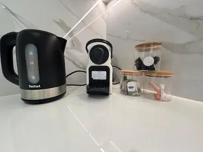 a coffee maker sitting on top of a counter at Modern & Cozy 1BR Apartment with Full Comfort in Dubai