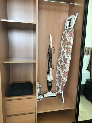 a cupboard with a hair dryer and a blender at Modern & Cozy 1BR Apartment with Full Comfort in Dubai