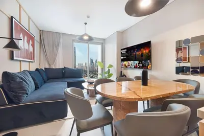 a living room with a blue couch and a wooden table at 4BR Luxury Hotel Amenities Dubai Mall Access in Dubai