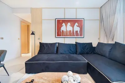a blue couch in a living room with a teddy bear at 4BR Luxury Hotel Amenities Dubai Mall Access in Dubai