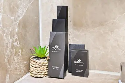 three boxes sitting on a table with a potted plant at 22nd Floor Burj Khalifa View 5 Min Walk Dubai Mall in Dubai