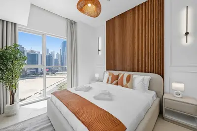 a bedroom with a large bed and a large window at Luxury 1BHK Burj Khalifa View Short Walk Dubai Mall in Dubai
