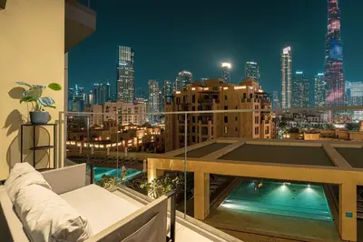 a balcony with a view of a city at night at Designer 2BR, Burj Khalifa View & Dubai Mall 2 minutes walk in Dubai