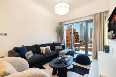 a living room with a couch and a large window at Designer 2BR, Burj Khalifa View & Dubai Mall 2 minutes walk in Dubai