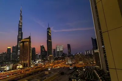 a view of a city skyline at night at Stylish 2 bedroom with Burj Khalifa View, connected to Dubai Mall in Dubai