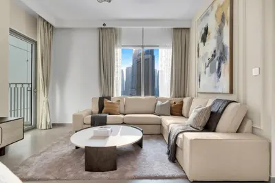 a living room with a couch and a table at Stylish 2 bedroom with Burj Khalifa View, connected to Dubai Mall in Dubai