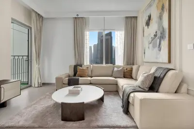 a living room with a couch and a table at Stylish 2 bedroom with Burj Khalifa View, connected to Dubai Mall in Dubai