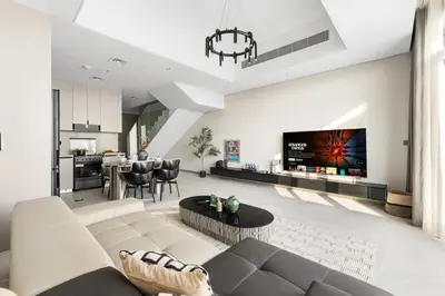 a living room with a couch and a table at 2.5BR Villa | PS5 & Private Pool | Near Dubai Mall in Dubai