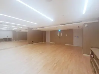 an empty room with a wooden floor and a white ceiling at Vacationer l Contemporary 1 Bedroom l Free Pool, Gym Access in Dubai