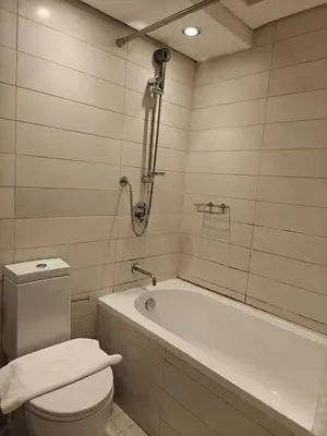 a bathroom with a toilet and a bath tub at Clear Burj Khalifa View Large Downtown Studio in Dubai