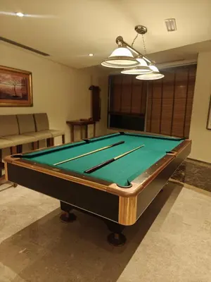 a pool table sitting in a living room with at Clear Burj Khalifa View Large Downtown Studio in Dubai