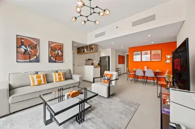 a living room with a couch and a table at Hermès 2BR Burj Khalifa & Fountain View With Direct Dubai Mall Access in Dubai