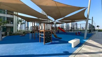 a playground with a canopy and a slide at Hermès 2BR Burj Khalifa & Fountain View With Direct Dubai Mall Access in Dubai