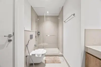 a bathroom with a shower and a toilet and a sink at Hermès 2BR Burj Khalifa & Fountain View With Direct Dubai Mall Access in Dubai