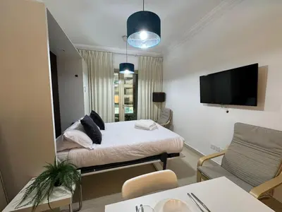 a bedroom with a bed and a large mirror at Cozy Studio in the Heart of Dubai Marina in Dubai