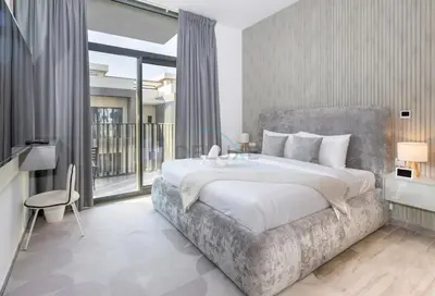 a bedroom with a large bed and a balcony at Central Location with Easy Access to Al Khail Road, Near Bus Stops, Supermarkets, Dining Spots, Minutes from Dubai Marina and Downtown - Belgravia Square B, JVC by Deluxe Holiday Homes in Dubai