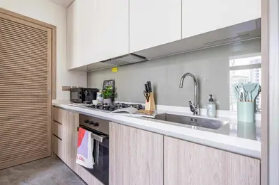 a kitchen with a sink and a counter at Frank Porter - Peninsula One in Dubai