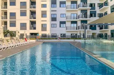 a swimming pool in front of a building at Silk Valley - Luxury 2B steps from Metro station in Dubai