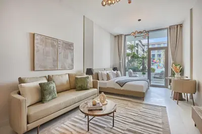 a living room with a couch and a table at Pool View Studio Near to circle mall - Icon casa Living in Dubai