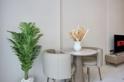 a dining room with a table and two chairs at Pool View Studio Near to circle mall - Icon casa Living in Dubai