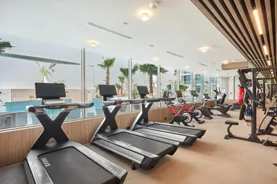 a gym with treadmills and cardio equipment in a building at Pool View Studio Near to circle mall - Icon casa Living in Dubai