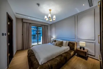 a bedroom with a large bed and a couch at Designer 2BR with Jacuzzi near Burj Khalifa in Dubai