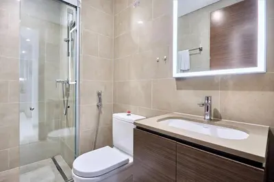 a bathroom with a toilet and a sink and a shower at STAY BY LATINEM Luxury 1BR Holiday Home CV B 1506 near Downtown in Dubai