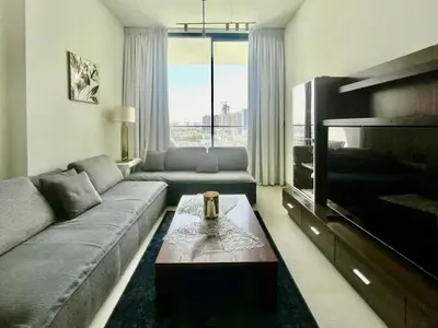 a living room with a couch and a coffee table at Tranquil 1BR in Binghatti Amber with Free Pool & Gym! in Dubai