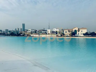 a large pool of water with a city in the background at Zapbed House-luxury one bedroom apartment in Residence 16 in Dubai