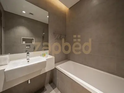 a bathroom with a sink and a bath tub at Zapbed House-luxury one bedroom apartment in Residence 16 in Dubai